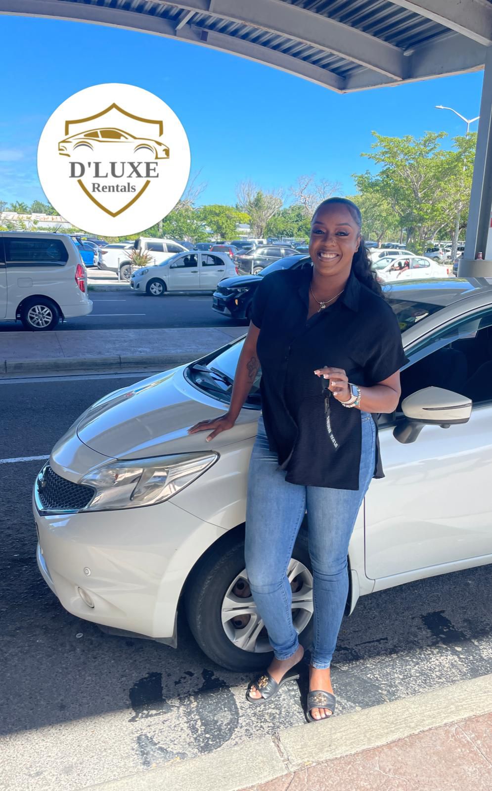 Happy D'Luxe Rentals customer with their rental car in Nassau