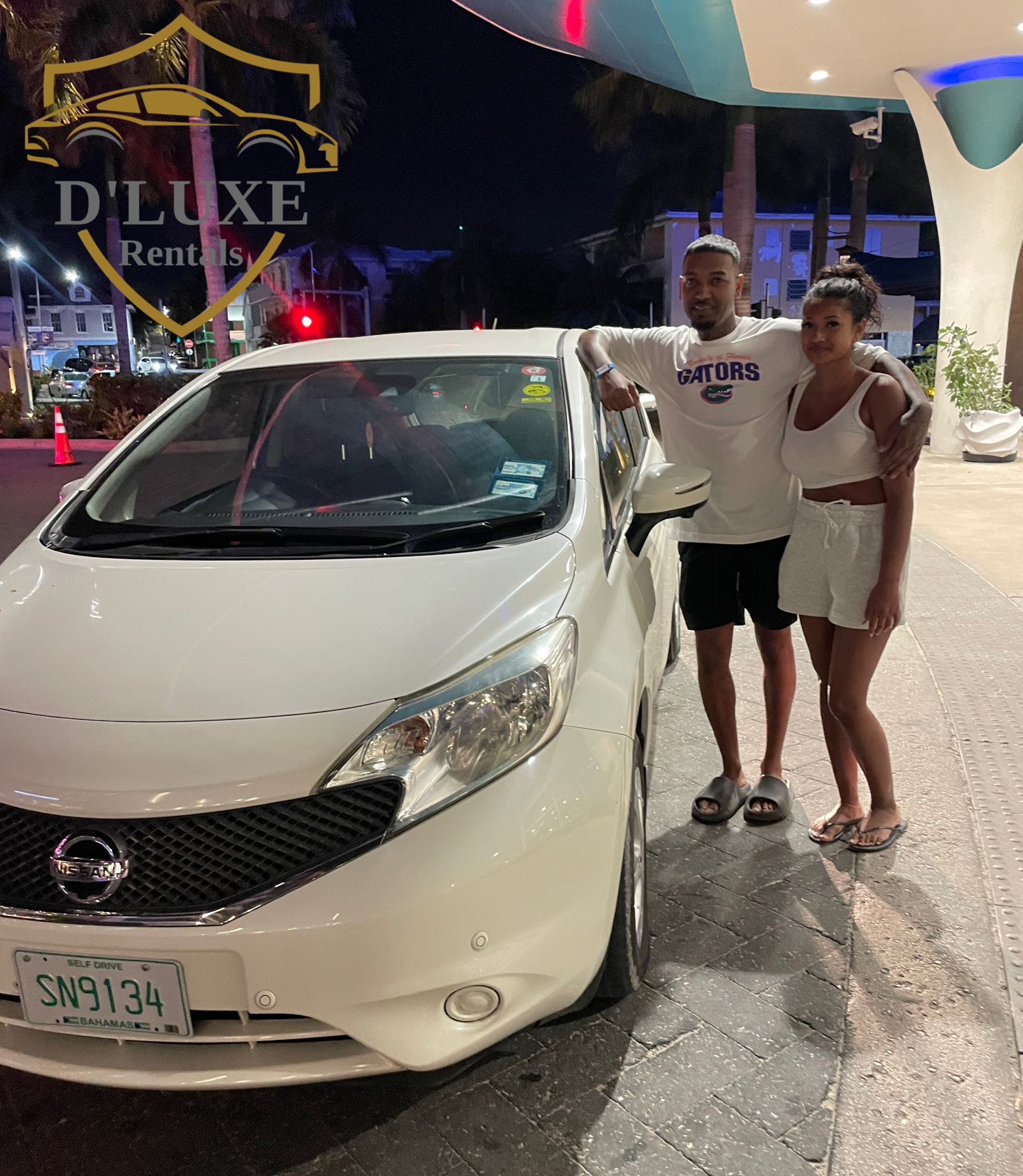 D'Luxe Rentals customer with compact rental car Nassau